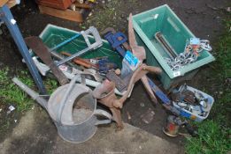 Two plastic containers, Stilsons, blow lamp, clamp on vice, galvanised watering can, etc.