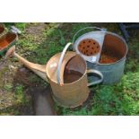 A galvanised watering can with rose and a mop bucket.