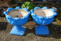 Two concrete planters painted blue, 17'' high x 19'' wide.