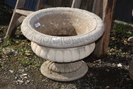 A planter with base, 13'' high x 19'' wide.