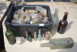 A quantity of old bottles including small poison bottles.