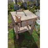 A wooden workbench with 4'' Record vice, 28'' x 25'' x 33''.