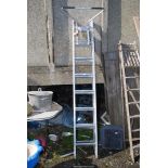 Eight rung triple extension ladder with standoff attachment.