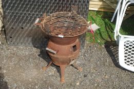 A cast BBQ stove, 15" diameter x 18 1/2" high.