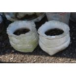 Two sack shaped concrete planters, 10'' high.