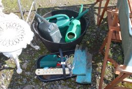 A garden trug, watering cans and a small quantity of garden tools.