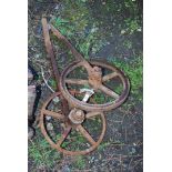 Two cast iron implement wheels.