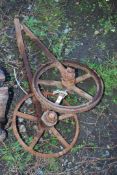 Two cast iron implement wheels.