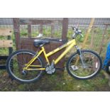 A yellow Raleigh Siren 21 speed ladies bike.