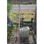 A hand cultivator, spade and jerry can.