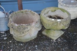 Two concrete planters, 15'' x 13'' high and 16'' x 11'' high.