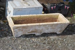 A long concrete planter trough, 32'' wide x 9'' high x 12'' deep.
