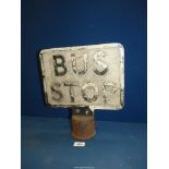 An old cast metal Bus Stop sign,