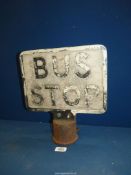 An old cast metal Bus Stop sign,