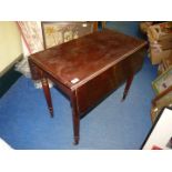A heavy dark Mahogany Pembroke Table standing on turned legs with brown china castors and having a