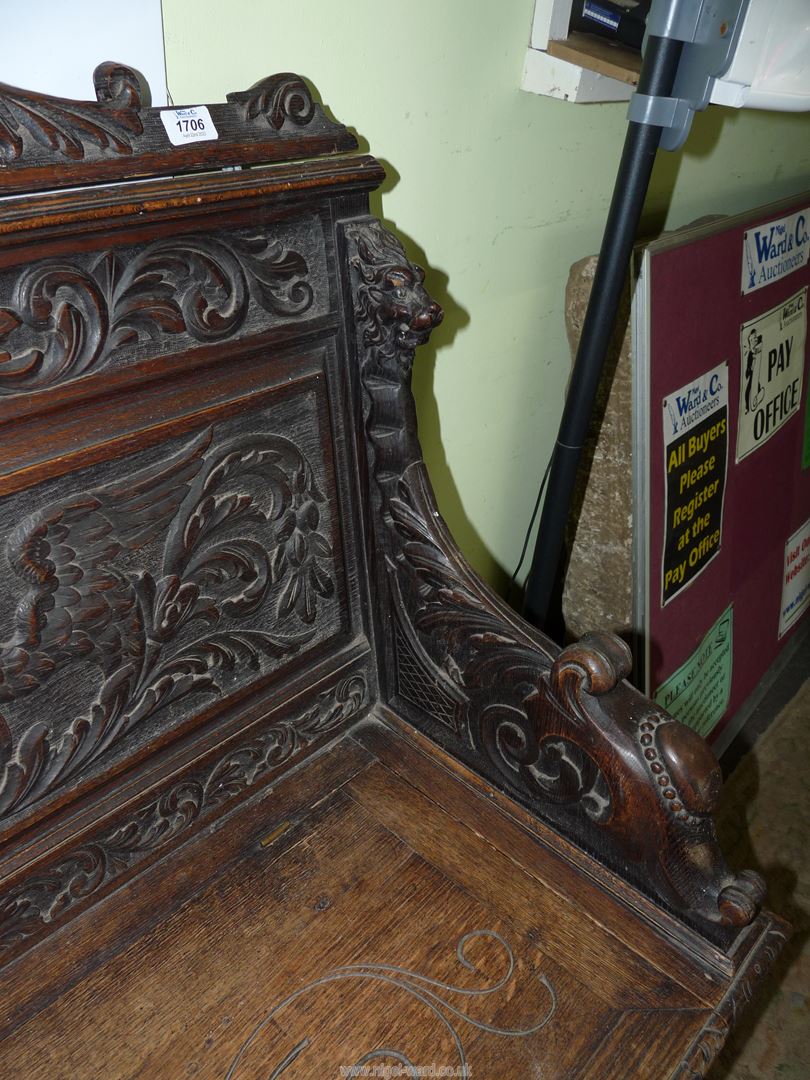 A profusely carved Oak Hall locker base Settle, the backrest with depictions of Phoenixes, - Image 7 of 9
