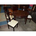 An oriental dark hardwood Chinoiserie circular Dining Table having a fretworked and carved frieze