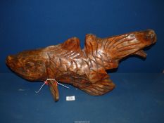 A carved figure of a Fish, 26" long x 17" high overall.
