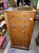 An Oak Wellington Chest having seven drawers with turned wooden knobs, 42" high,