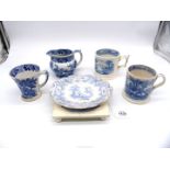 A quantity of early Staffordshire blue and white mugs, jug, stand and Coalport teapot stand.