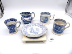 A quantity of early Staffordshire blue and white mugs, jug, stand and Coalport teapot stand.