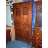 A full height Georgian Oak Corner Cupboard having contrasting beading to the panels and having two