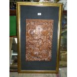 An ornately carved Panel depicting horses pulling a chariot, mounted on Hessian backing,