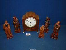 Five Chinese carved figures and an inlaid wooden cased Mantle clock on brass feet having Arabic