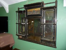 An ebonised and gilt decorated Overmantel Mirror having a bevelled mirror with a scene of