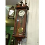 A Walnut/Mahogany cased Vienna type Wall Clock having a single train weight driven movement,