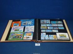 A brown Stamp Album and contents including 'History of Aviation" mint stamps from Rwanda, Paraguay,
