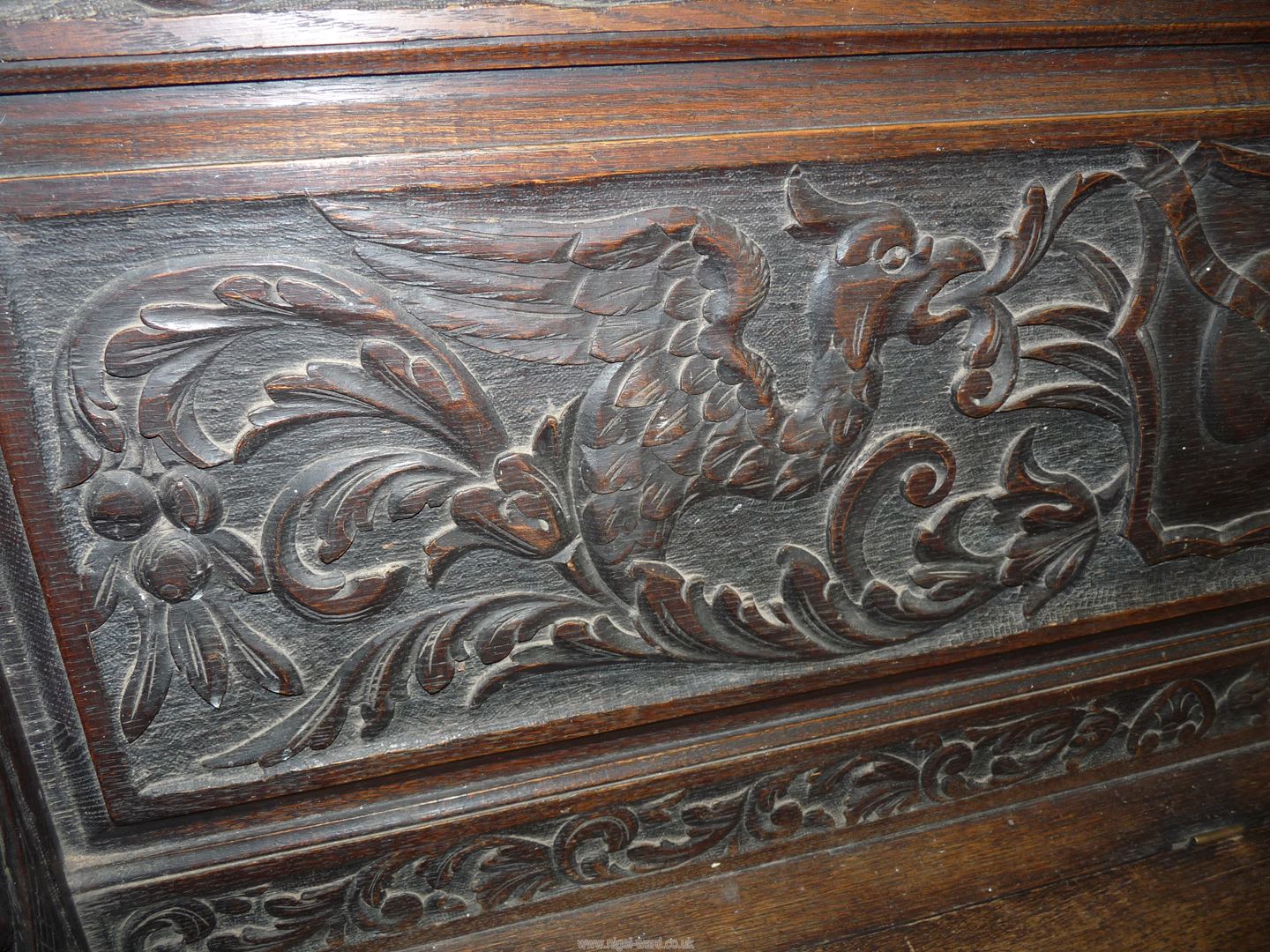 A profusely carved Oak Hall locker base Settle, the backrest with depictions of Phoenixes, - Image 5 of 9