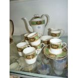 A pretty continental coffee service having white ground with border of green and a floral panel in