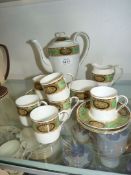 A pretty continental coffee service having white ground with border of green and a floral panel in