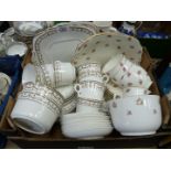 A Cauldon part tea set, white with pink roses including three cups and five saucers,