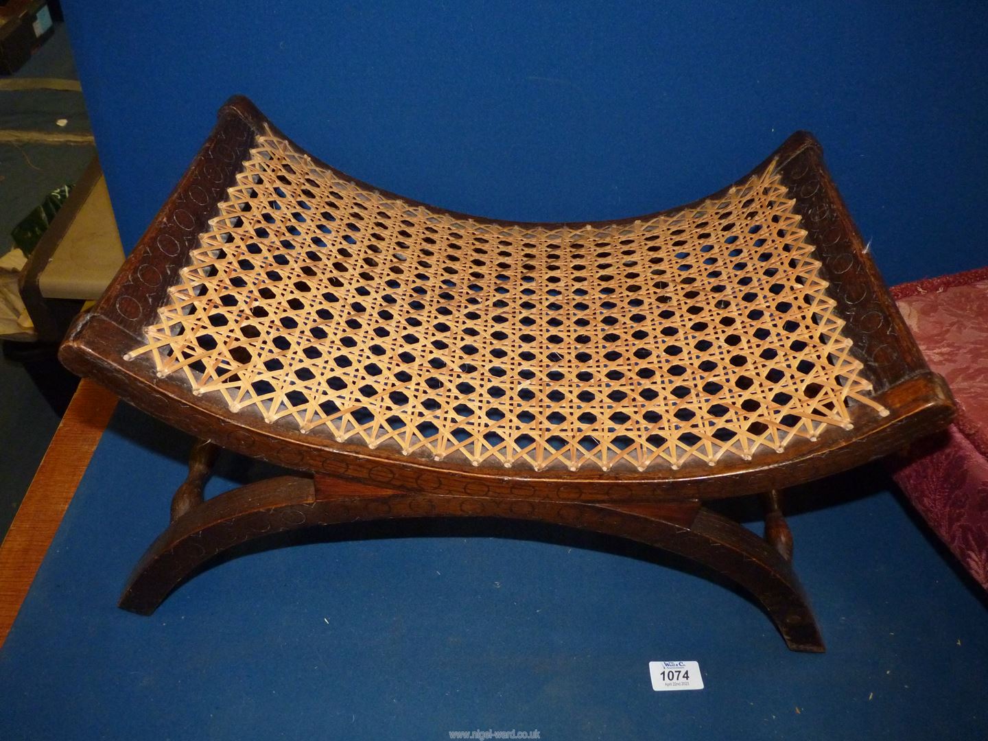 A low Oak stool with curved cane seat with carved details, - Image 2 of 2