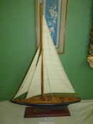 A wooden model of Sailing boat mounted on wooden plinth, 24" x 34".