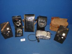 Four cameras including Minolta Riva Zoom 70, Ensign Pocket 20 and two old Kodak cameras.