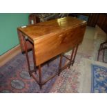 A 19th Century Mahogany Sutherland drop-leaf gate-leg table standing on spindle legs and stretchers