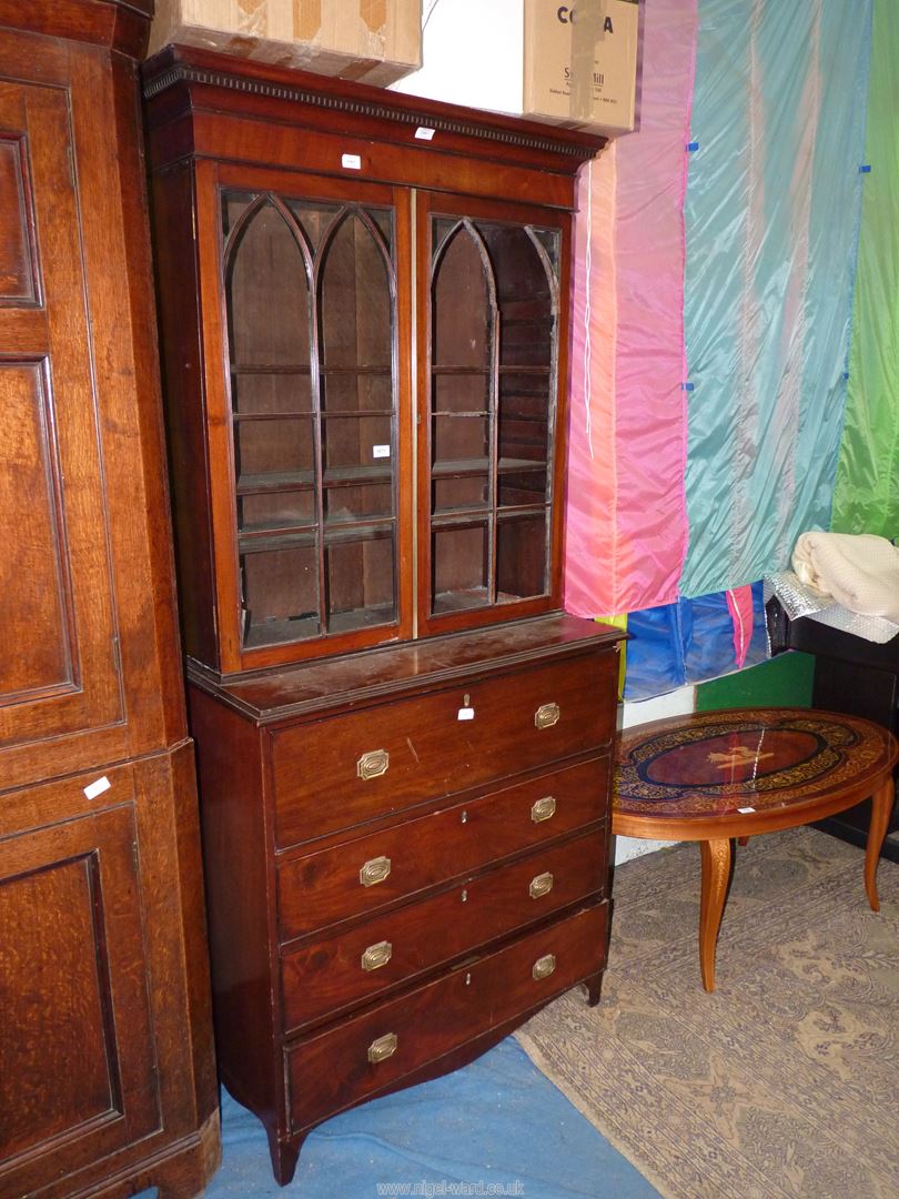 A compact and desirable Mahogany secretaire Bookcase having Gothic arch shaped glazed doors (one