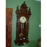 A Mahogany and Walnut cased Gustav Becker Vienna type Wall CLock having a two train weight-driven