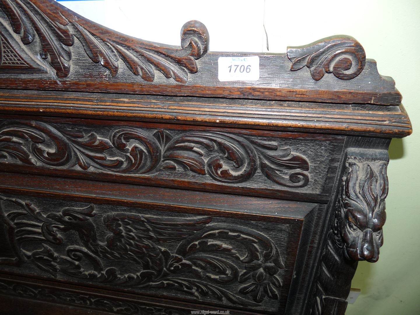 A profusely carved Oak Hall locker base Settle, the backrest with depictions of Phoenixes, - Image 8 of 9