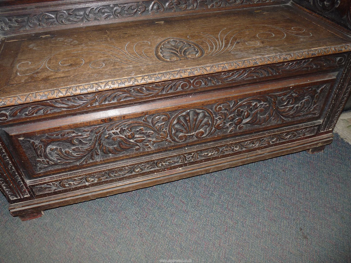 A profusely carved Oak Hall locker base Settle, the backrest with depictions of Phoenixes, - Image 6 of 9