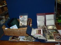 A basket of British Post Office picture Card Albums and contents of cards featuring Post vans in