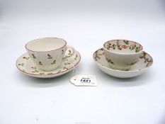 A Coalport cup and saucer with single buds and foliage in circular pattern on saucer and all over