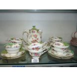 A part Paragon Rockingham tea set consisting of hot water jug, six cups, two small saucers,