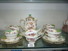 A part Paragon Rockingham tea set consisting of hot water jug, six cups, two small saucers,