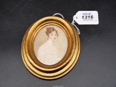 A finely painted miniature head and shoulders Portrait of an attractive young woman,