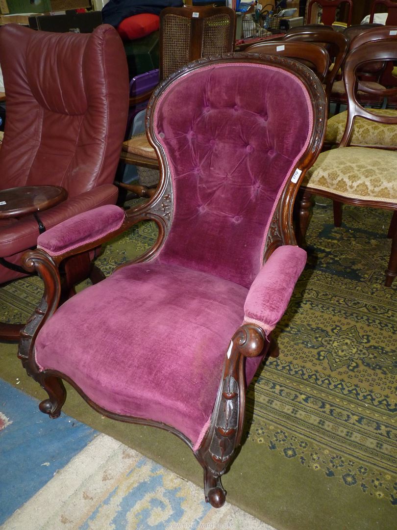 A Mahogany/Walnut framed Victorian button-backed open armed Armchair having art nouveau style