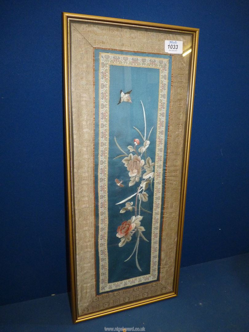 A framed Chinese embroidered panel, 24'' high x 10'' wide including frame.